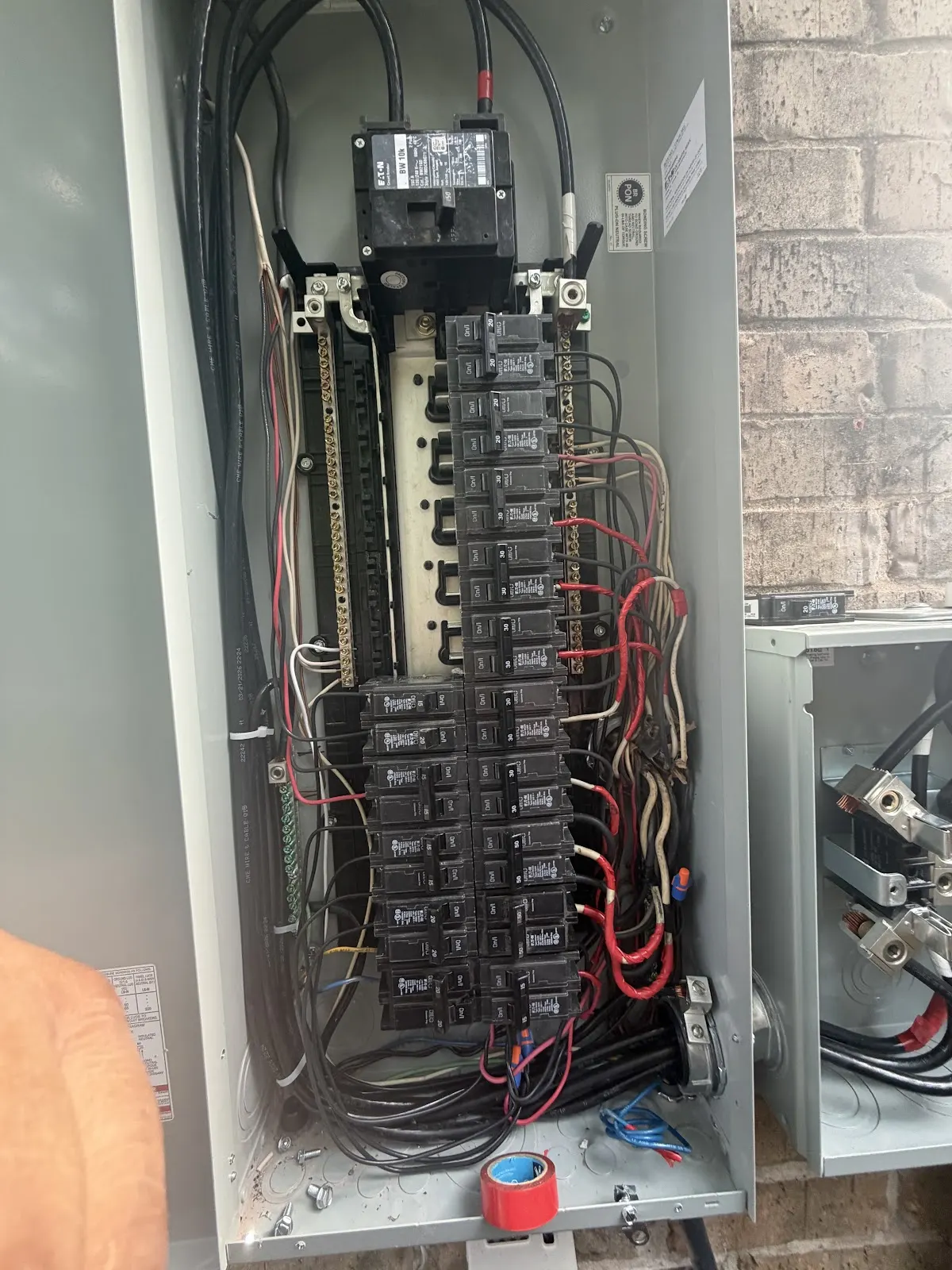 Open breaker panel with neatly dressed wiring, worked on by Pro Max Electrical