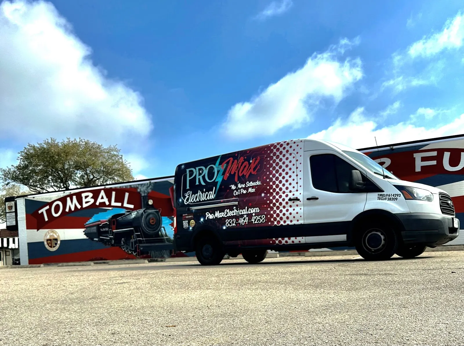 Pro Max Electrical van parked in front of a painted Tomball mural